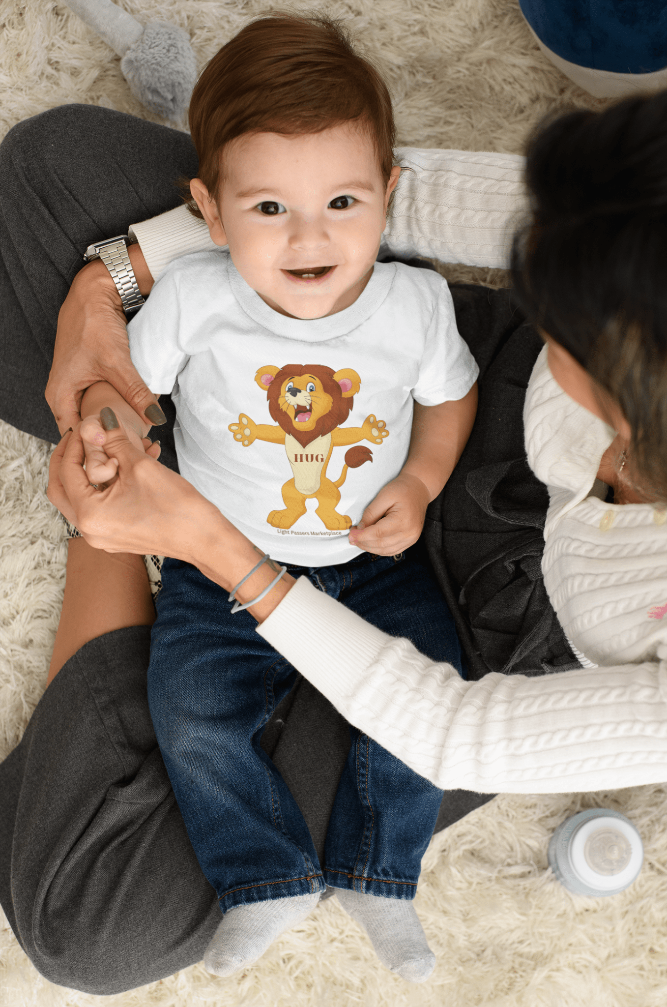 A toddler tee featuring a cartoon lion design, ideal for sensitive skin. Made of 100% combed cotton, light fabric, and a tear-away label for comfort.