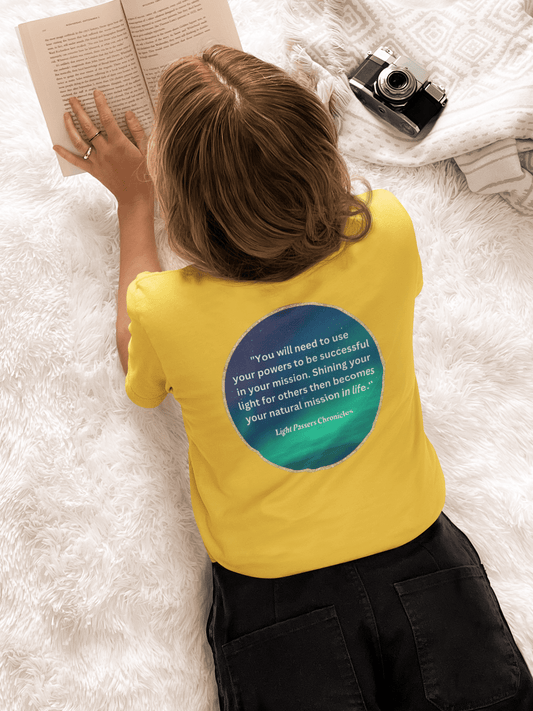 A person reading a book on a Use Your Powers turquoise circle Unisex T-shirt back, showcasing a close-up of a camera lens. Classic fit, 100% cotton tee with smooth surface for premium printing.