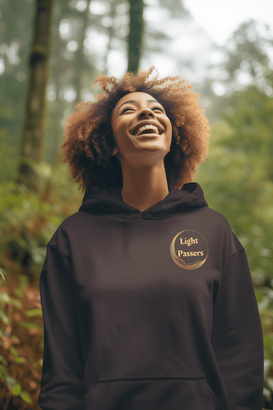 A woman smiling in a hoodie with a close-up of a logo, showcasing the Small LP Logo Unisex Hoodie Sweatshirt. Made with a cozy cotton-polyester blend, featuring a kangaroo pocket and color-matched drawstring for style and comfort.