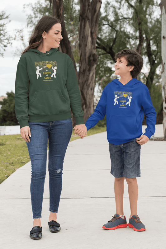 A woman and boy hold hands, showcasing the Light of Love Gold Heart Youth Hooded Sweatshirt. Made of soft fleece, 50% cotton 50% polyester, with kangaroo pocket and twill taping.