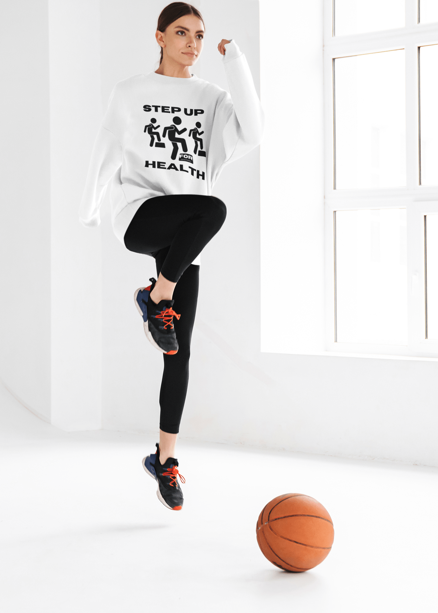 Fitness Motivation Crewneck Sweatshirt - Step up for Health: Woman jumps in the air holding a basketball, showcasing the sweatshirt's relaxed fit and activewear style.
