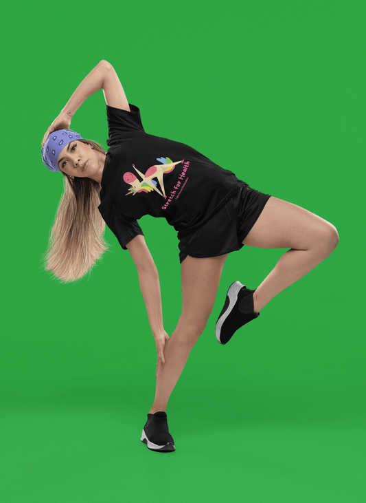 Young woman in sporty attire wearing the Health Women's Tee - Magical Unicorn Stretch for Health, performing a side-balance stretch, showcasing vibrant unicorn graphics.