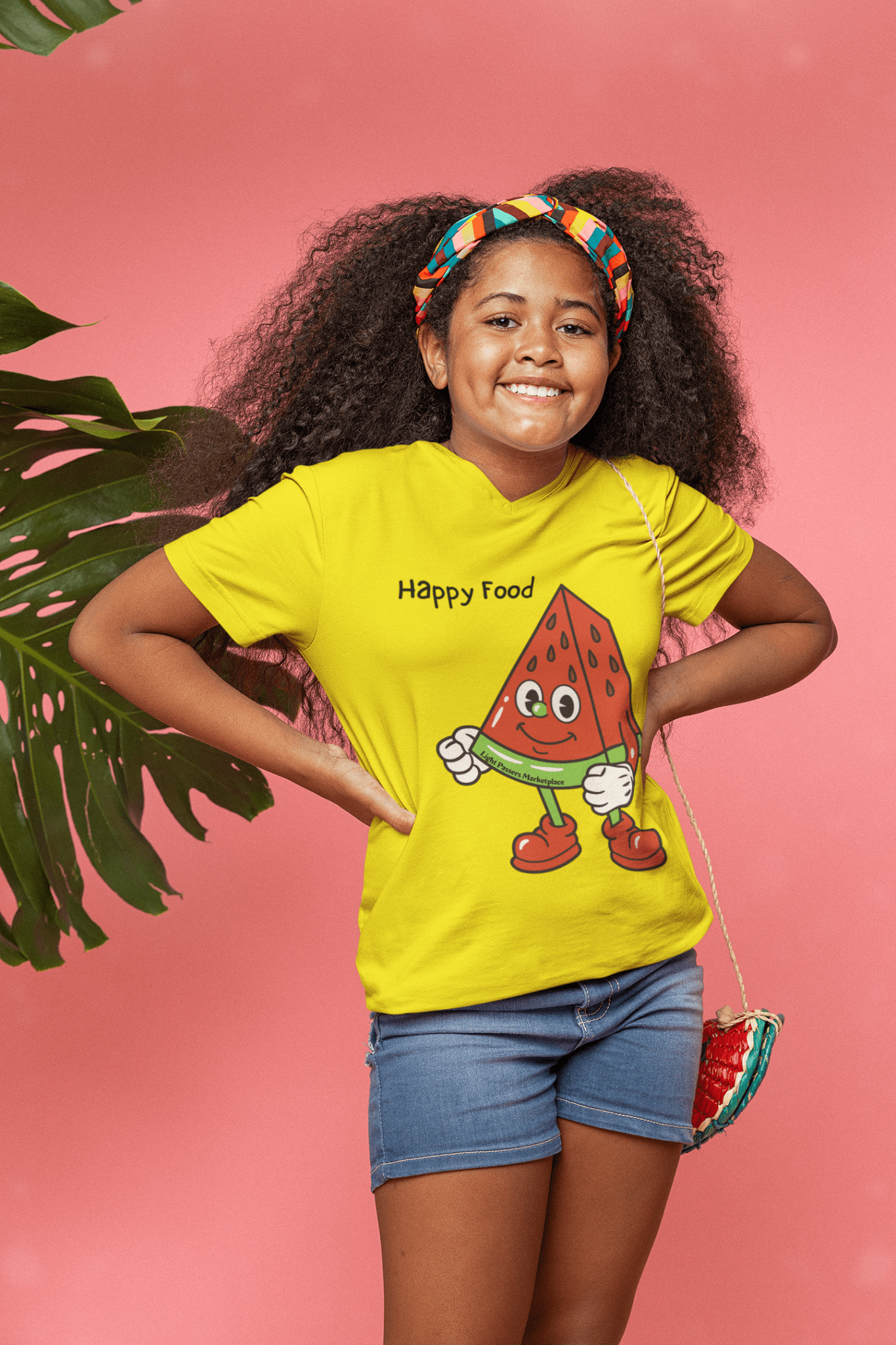 A girl in a Happy Food Watermelon Youth T-shirt, posing with hands on hips, showcasing the tee's 100% cotton fabric, twill tape shoulders, and ribbed collar for durability and comfort.