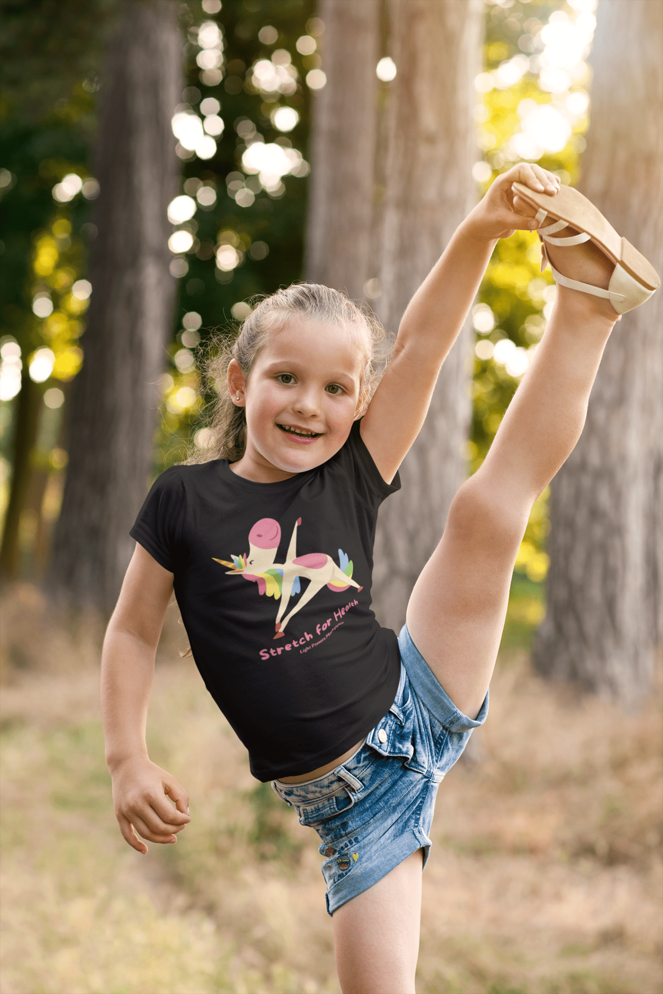 A toddler's Unicorn Stretch Yoga T-shirt, featuring a girl doing a leg split. Soft 100% cotton, durable print, tear-away label, light fabric, classic fit. Ideal for sensitive skin, first adventures.