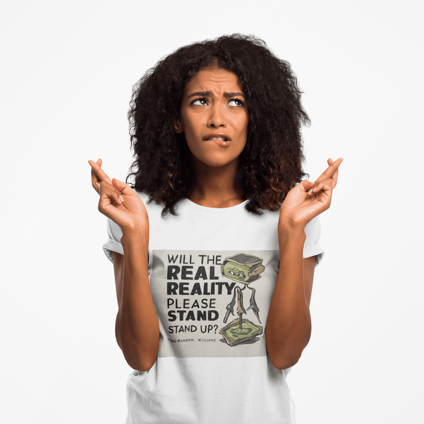 Young woman with curly hair wears the Will the Real Reality Please Stand Up T-shirt from Light Passers Marketplace, featuring a cartoon creature and text.